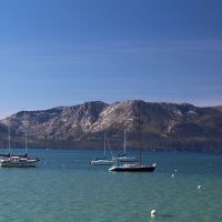 boats on lake tahoe with sierra range in background