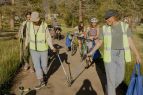 Volunteers picking up trash around the bike path. 