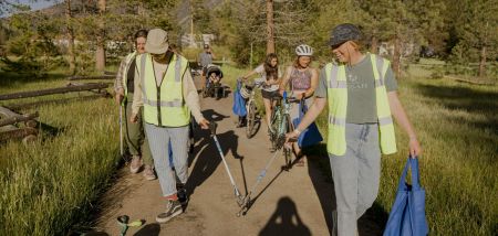 Volunteers picking up trash around the bike path. 